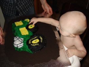 Attacking his 1st birthday cake!